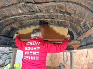 Glencoe Folk Museum coffin boat interior being held up by Stephen Beresford.