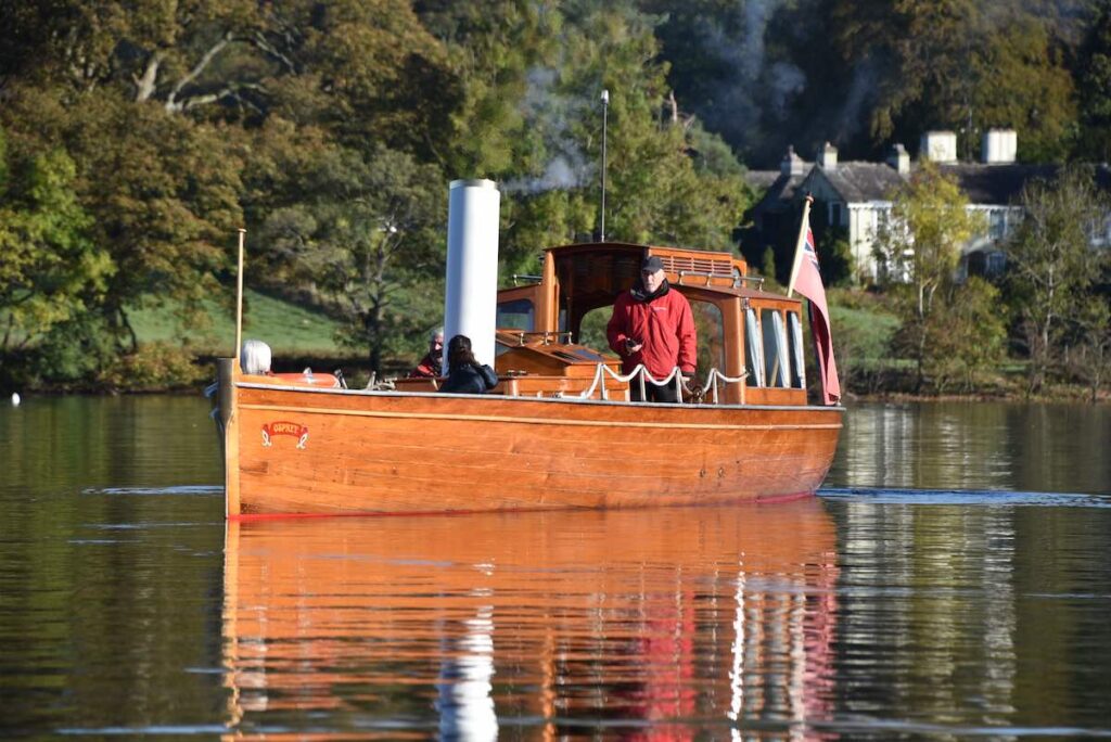 People enjoying a boat tour across Windermere on heritage Steam Launch Osprey on a beautiful sunny day.