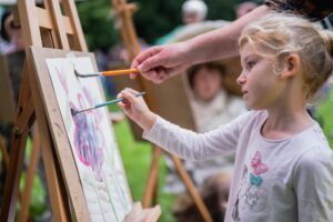Child having a go at watercolour still life painting at Abbot Hall.