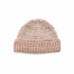 Old rose and ecru coloured beanie on a white background.