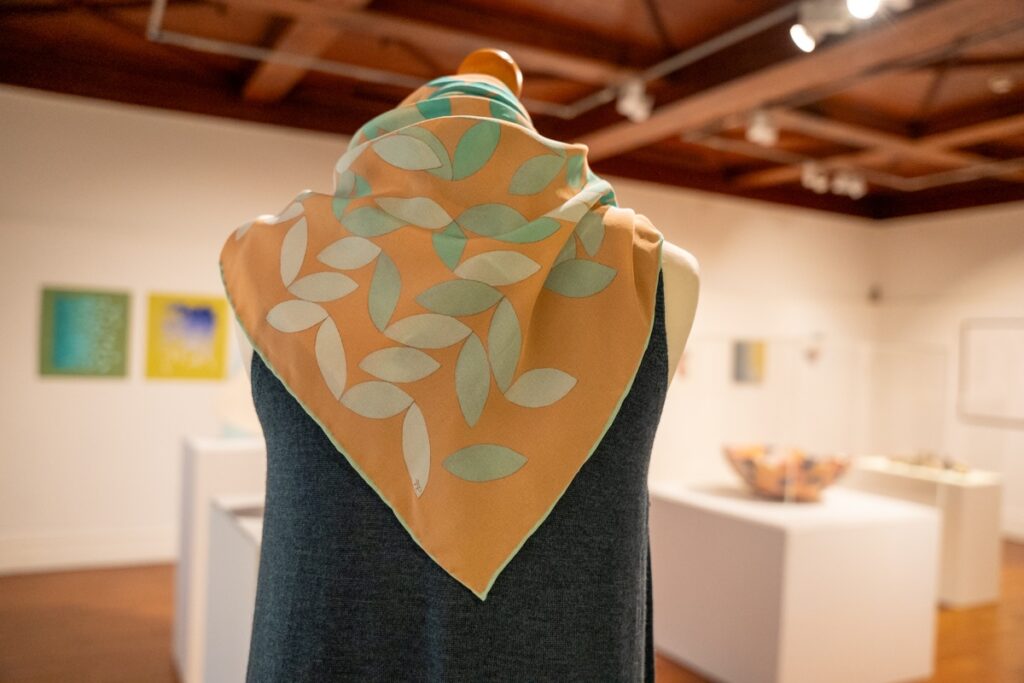 Limited Edition scarf by Frances Priest styled on a mannequin on display in the exhibition space.