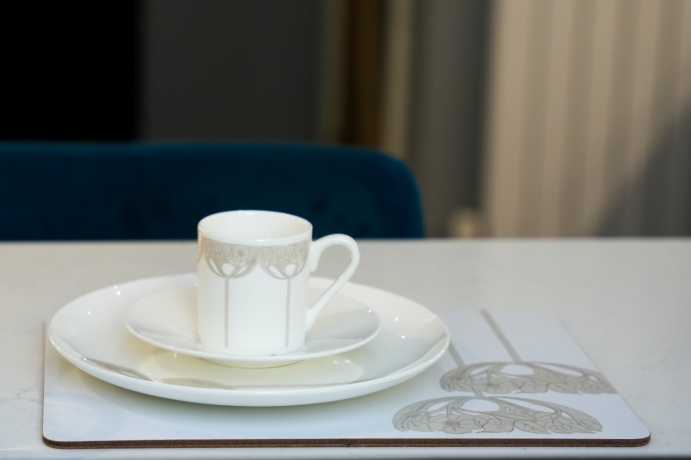 Mackay Hugh Baillie Scott inspired placemats, espresso cup, saucer, plate and coaster set out ready for a meal at breakfast bar in modern kitchen.