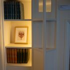Framed illustration of the rowan berry design featured throughout Blackwell on display on a built-in bookshelf at Blackwell – the Arts & Crafts House, surrounded by decorative books and interior details.