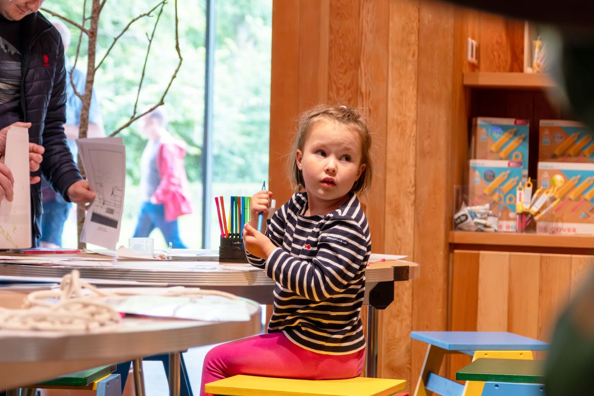 Child having fun with the Arthur Ransome-inspired craft activities available in the foyer area at Windermere Jetty Museum.